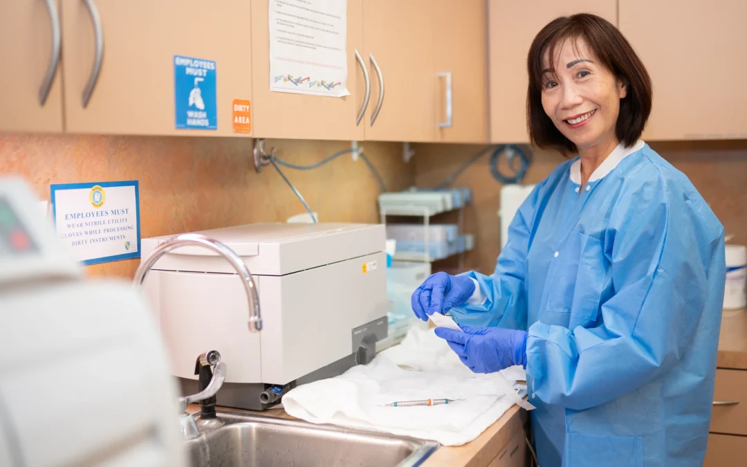 Team member preparing dental instruments in the sterilization area at Best Natural Smile